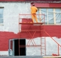 man painting house